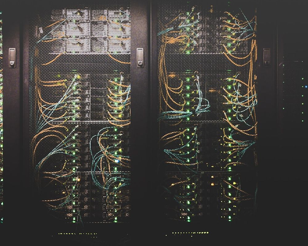 Rak server dengan kabel jaringan tertata dan lampu indikator menyala